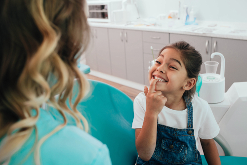 young girl showing her teeth