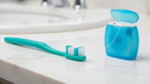 toothbrush-and-dental-floss-on-a-bathroom-counter-emphasizing-dental-hygiene