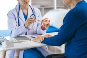 Asian,People,Female,Dentist,Imparts,Valuable,Advice,To,Elderly,Male