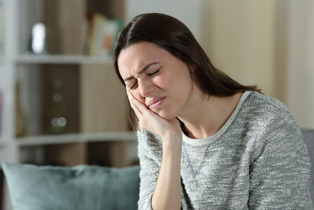 Stressed,Woman,Complaining,Suffering,Toothache,Sitting,On,A,Couch